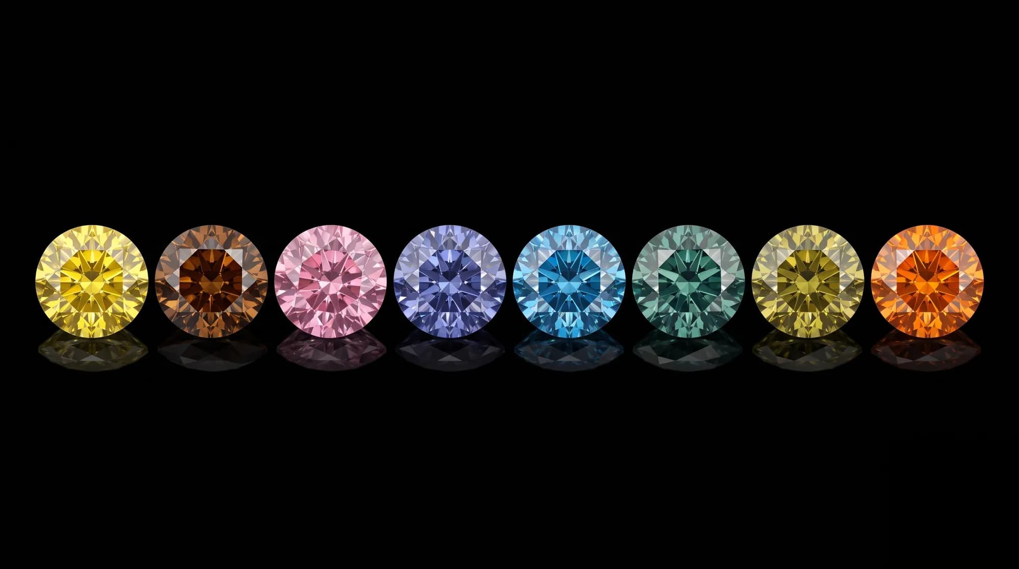 Osiem naturalnych diamentów kolorowych (fancy color) w szlifie brylantowym — żółty, koniakowy, różowy, fioletowoniebieski, niebieski, zielony, oliwkowy i pomarańczowy — na czarnym tle, z odbiciami.
